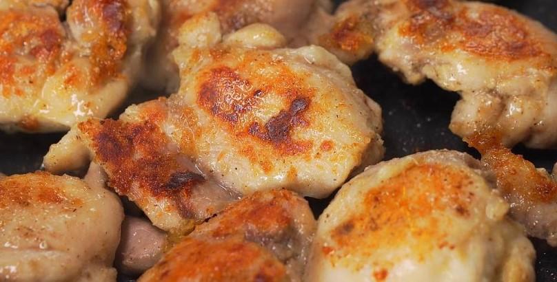 Курячі стегна з грибами та часником на сковороді